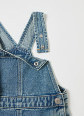 Denim dungarees with abrasions